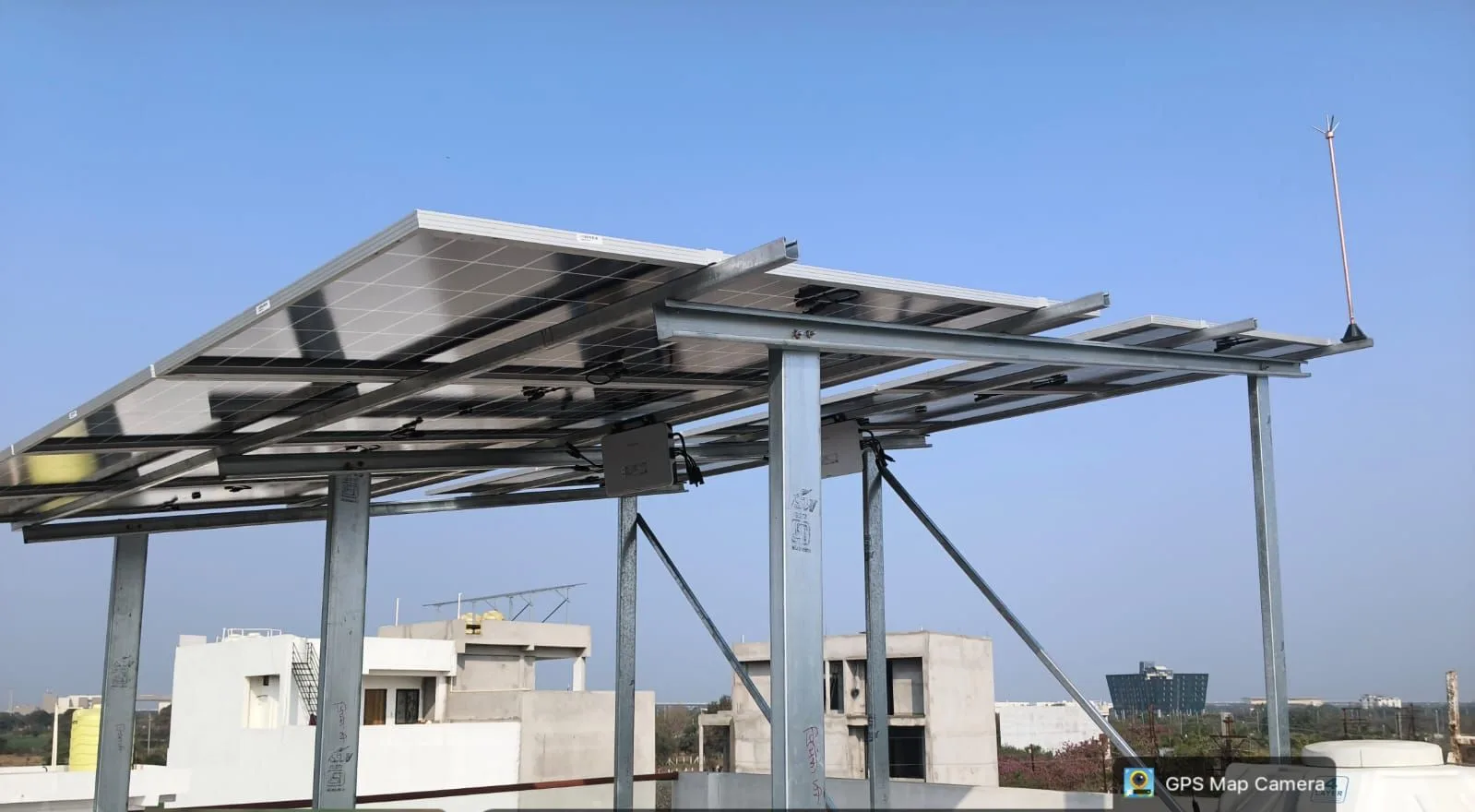 High-clearance galvanized solar frame spanning a rooftop in Indore