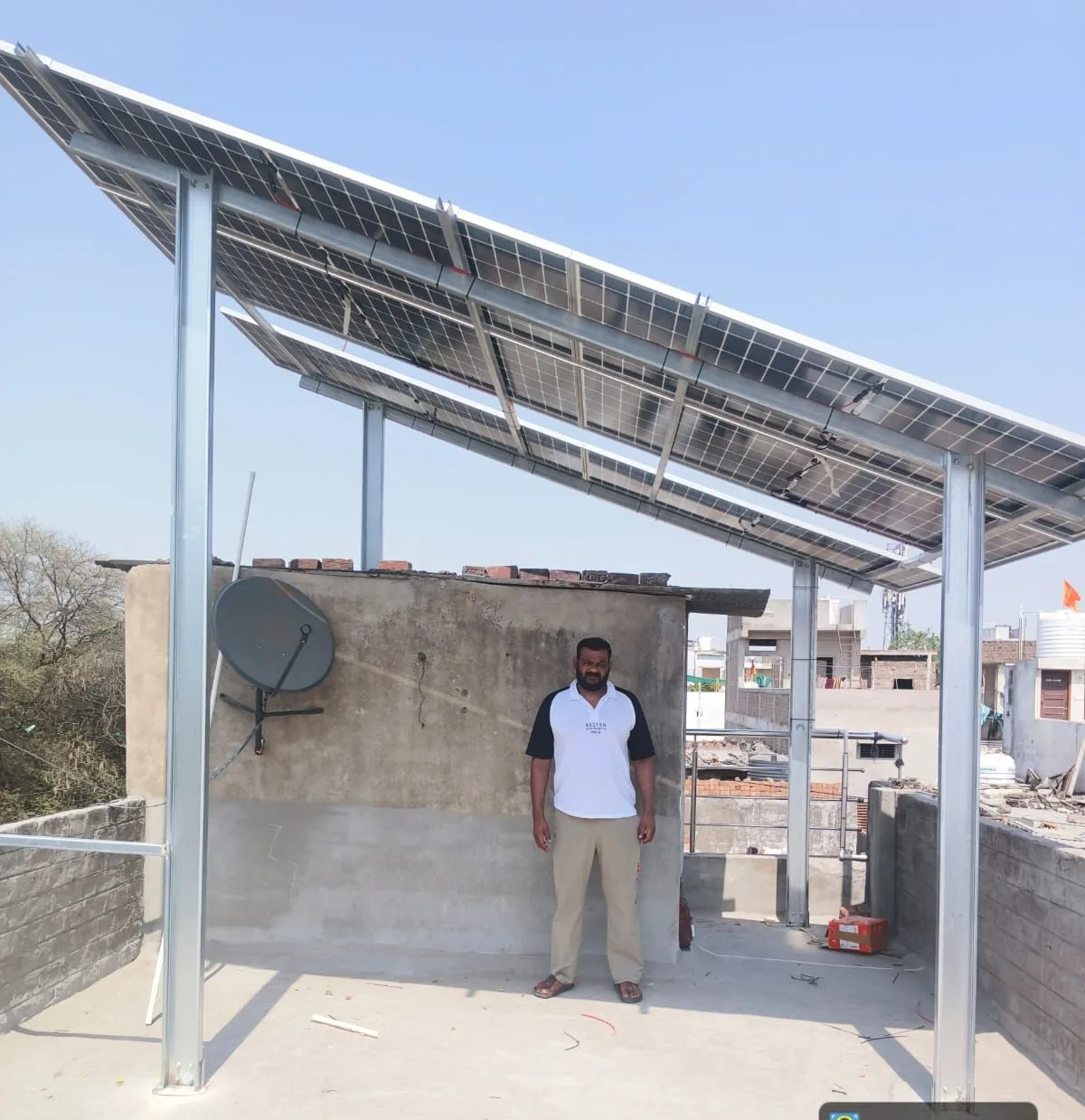 A G-9 engineer fitting a solar module onto a rooftop mounting structure
